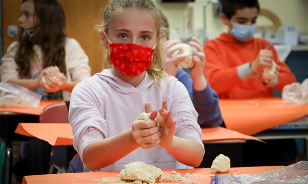 Girl shapes salt dough